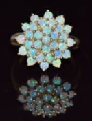 A 9ct gold ring set with a cluster of opals, 3.5g, size N