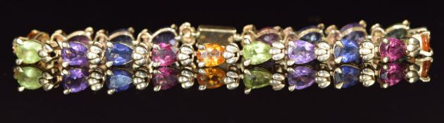A 9ct gold bracelet set with pear cut garnets, citrines, peridot, amethysts and tanzanites, 9.3g,