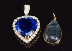 An 18ct gold pendant set with blue synthetic spinel surrounded by clear paste (10.6g, 3.2cm) and a