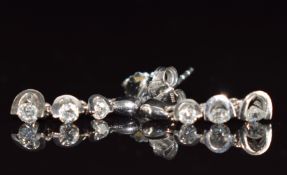 A pair of 18ct white gold earrings each set with three diamonds, 2.2g, with original receipt for £