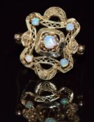 A 14k gold ring set with opals in a pierced setting, 7.4g, size P