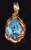 A 14k gold pendant set with a pear cut topaz, 2.8cm, 3.9g