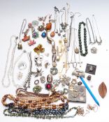 A collection of costume jewellery including Exquisite brooch, other brooches, necklaces, watches,