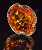 A 9ct gold set with a large oval mixed cut synthetic orange sapphire, 8.1g, size O