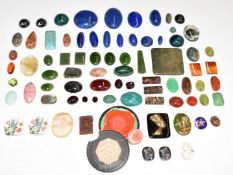 A collection of loose cabochons including garnet, moss agate, carnelian agate, sunstone,