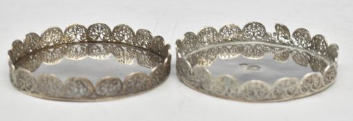 Pair of Iranian silver coasters, with filigree borders, diameter 9cm, weight 148g