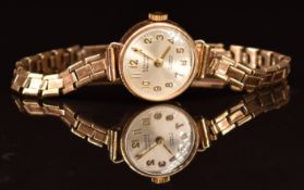 Limit 9ct gold ladies wristwatch with gold hands and Arabic numerals, silver dial and 17 jewel