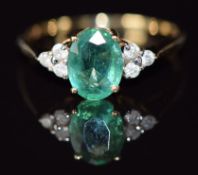 A 14k gold ring set with an oval cut emerald of approximately 1.2ct and diamonds, 1.6g, size N