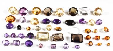 A collection of loose amethysts, citirines and smoky quartz