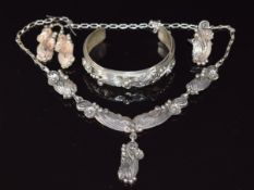 A suite of silver Navajo jewellery comprising bangle, necklace, ring and earrings