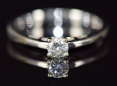 An 18ct white gold ring set with a round brilliant cut diamond of approximately 0.25ct, with