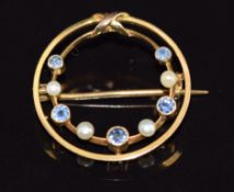 A 9ct gold c1915 circular brooch set with sapphires and seed pearls, 1.8g, 2.3cm