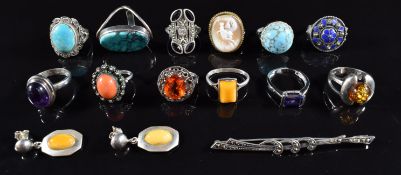 Twelve silver rings set with turquoise, coral and amber together with silver brooch and a pair of