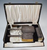 Cased Art Deco style hallmarked silver dressing table set comprising hand mirror and two brushes,