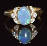 A 9ct gold ring set with black opal cabochon and diamonds, 2.7g, size N