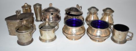 Twelve various hallmarked silver salts, mustards and peppers, most with blue glass liners, including
