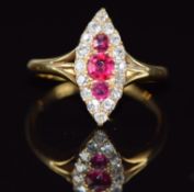 Edwardian 18ct gold ring set with rubies and old cut diamonds in a marquise shaped setting,