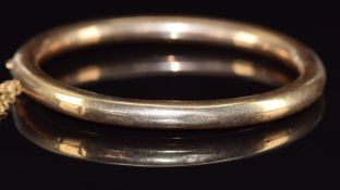 A 9ct gold bangle, 11.9g, 5.7 x 5cm