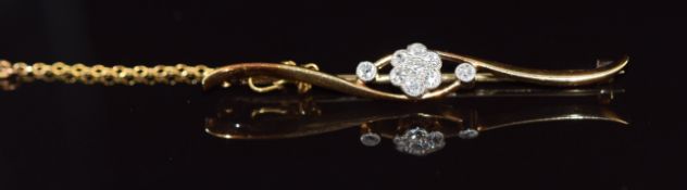 An 18ct gold brooch set with diamonds in a floral cluster, 3.6g, 4.5cm