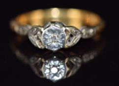 An 18ct gold ring set with a diamond in a platinum setting, 2.6g, size M