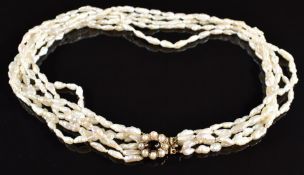 A six strand pearl necklace, the 9ct gold clasp set with a garnet cabochon and split pearls, 40cm