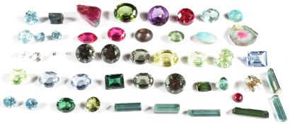 A collection of loose tourmalines, topaz, synthetic rubies, synthetic purple sapphire and zircons