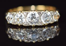 An 18ct gold ring set with five old cut diamonds, the centre diamond approximately 0.5ct and eight