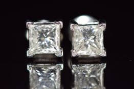 A pair of platinum earrings set with a princess cut diamond of approximately 1ct to each, 3.7g