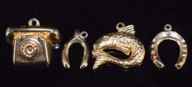 Four 9ct gold charms / pendants comprising fish, horseshoe, wishbone and telephone, 2.4g