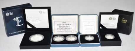 Four Royal Mint silver proof coins to include 'A moment that lasts a lifetime' £5, two £1 examples