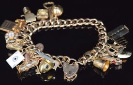 A 9ct gold charm bracelet with twenty two 9ct gold charms including telephone '2 tel U I love
