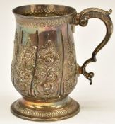 Georgian hallmarked silver pint tankard with embossed decoration and scrolling handle, London