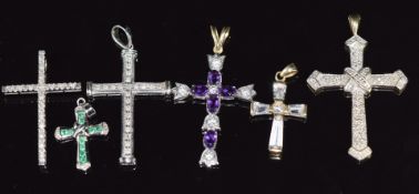 Three 9ct white gold cross pendants set with diamonds and emeralds and three 9ct gold pendants set