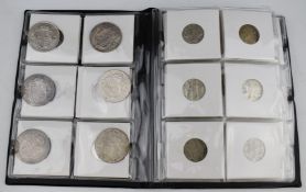 A small coin collector's album containing largely half crowns, a good proportion pre 1947, with some