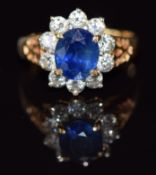 An 18ct gold ring set with a sapphire of approximately 0.8ct surrounded by diamonds, 3.3g, size J