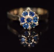 A 9ct gold ring set with sapphires in a cluster, 2.6g, size N