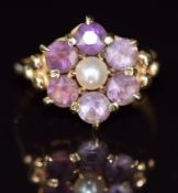 A 9ct gold ring set with a pearl surrounded by amethysts, 3.5g, size M