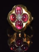Victorian ring set with four foiled garnets and a diamond to the centre, with faceted decoration