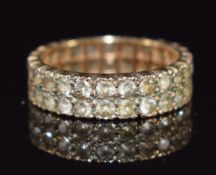 A 9ct gold eternity ring set with two rows of spinel, 3.1g, size K