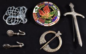 Three Scottish silver brooches/ pins, silver gilt brooch with enamelled Canadian leaf, and two