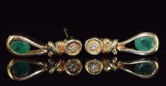 A pair of 9ct gold earrings set with an oval cut emerald and diamond to each, 2.2g, 1.3cm