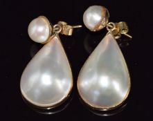 A pair of 9ct gold earrings set with a pearl and a pear shaped pearl cabochon to each, 7.6g, 3cm