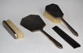Hallmarked silver dressing table set comprising hand mirror and two brushes Birmingham 1938/9, maker