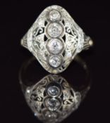 An 18ct gold ring set with four old cut diamonds with further diamonds in a pierced platinum