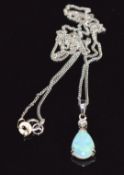 A 9ct white gold pendant set with a pear cut opal cabochon (0.6g) and diamond on 18k white gold