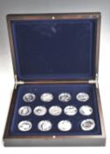 Thirteen crown sized silver coins commemorating famous aircraft, in deluxe fitted wooden case