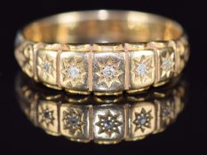 Edwardian 18ct gold ring set with five diamonds in star settings, 5.1g, size S
