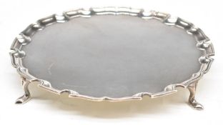 George V hallmarked silver salver with shaped edge, raised on four feet, London 1935, maker Edward
