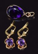 A 9ct gold pendant set with an pear cut amethyst and a pair of 18ct gold earrings set with an oval
