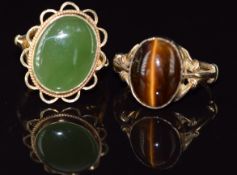Two 9ct gold rings, one set with a tiger's eye cabochon the other jadeite, 6.8g, size N